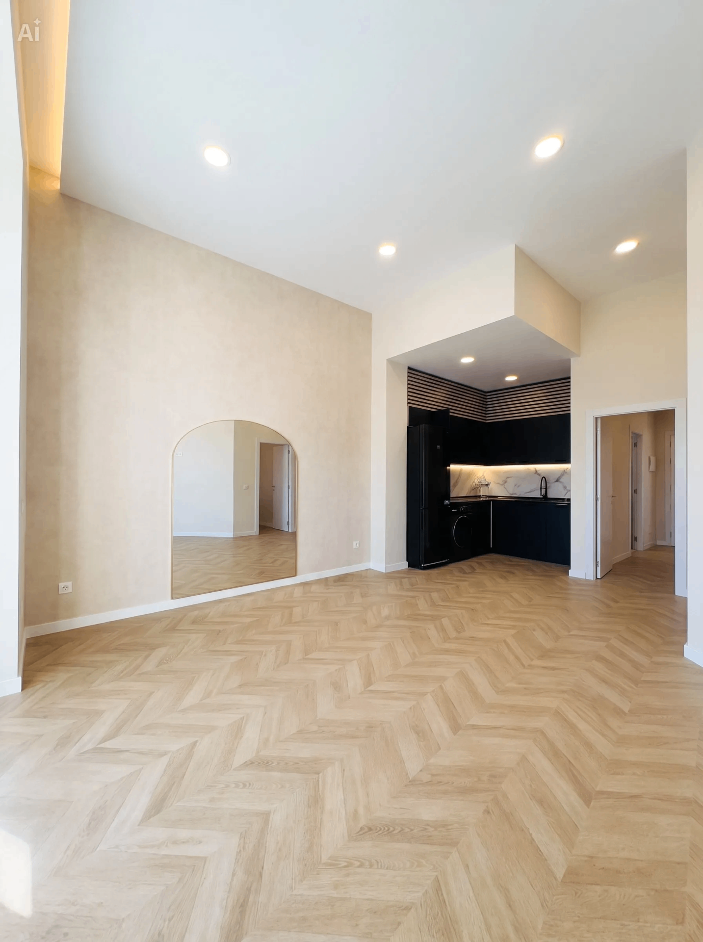 Salón diáfano con suelo de espiga, espejo arco y cocina integrada